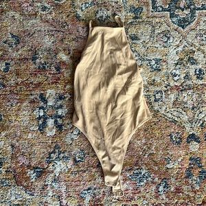 Nude body suit with side openings